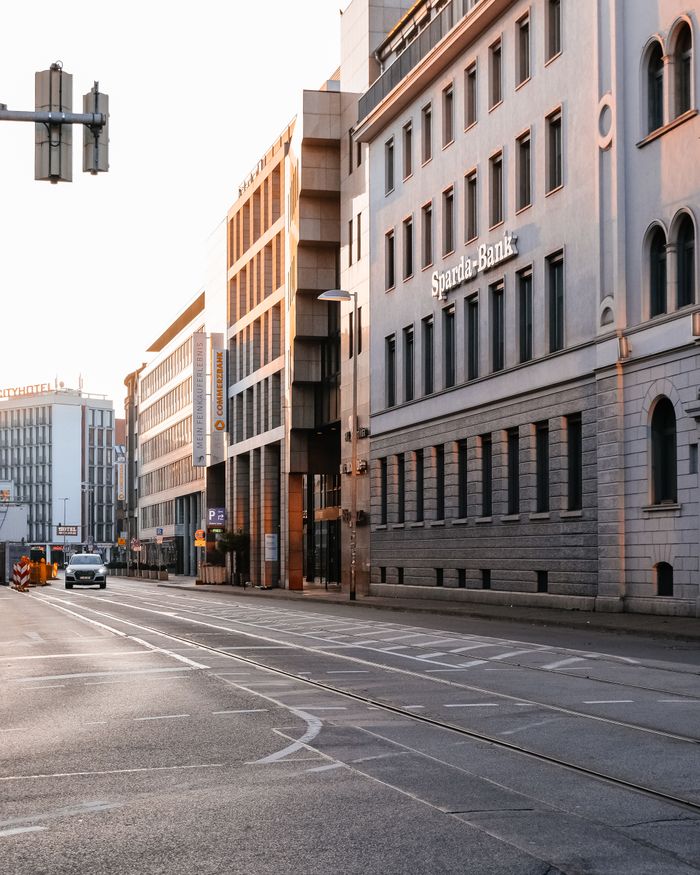 Mastering the First Impression: Your intriguing post title goes here Peaceful city street scene with contemporary buildings and warm sunset lighting.