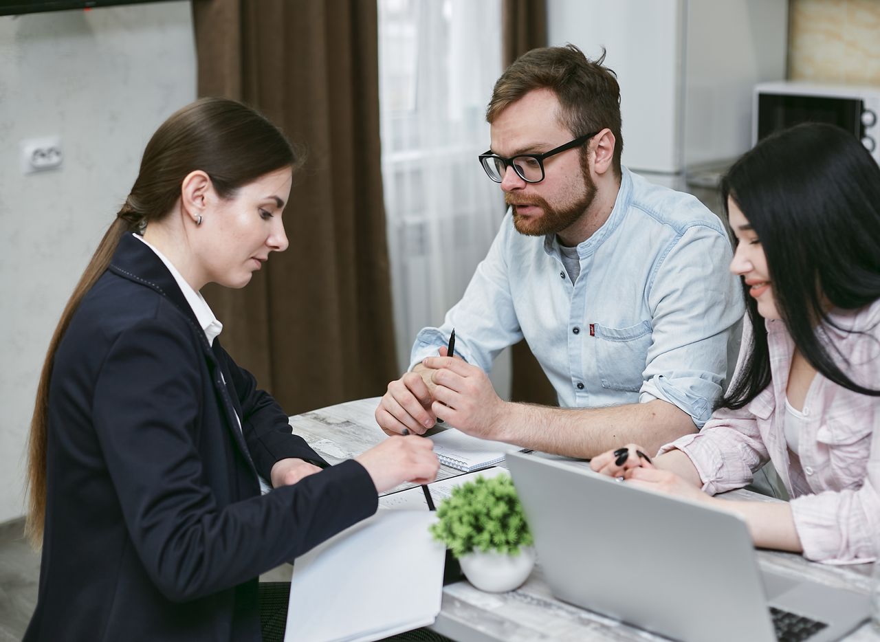 Crafting Captivating Headlines: Your awesome post title goes here A couple discusses financial documents with their advisor, highlighting investment strategies.